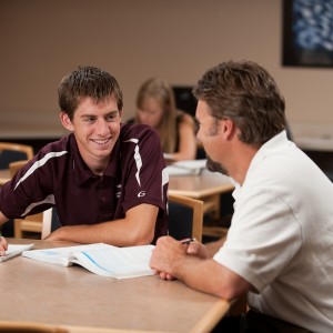 Elliot Wilder ’11, Hesston, Kan., gets help from business faculty David LeVan in the ACCESS lab.