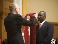 Hesston College Pastoral Ministries graduate Bernard Sejour receives a stole from program director David Greiser.