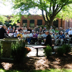 A crowd gathers to dedicate the Freedley Schrock memorial at Hesston College