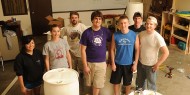 The Hesston College Entrepreneurship class takes a break from turning 55-gallon food-grade drums into rain barrels. Pictured from left are sophomores Brenda Nieto-Montoya (Three Rivers, Mich.), Mallory Schroeder (Newton, Kan.), business instructor David LeVan, Kyle Albrecht (Clarence, N.Y.) and Hayden Goerzen and freshmen Matt Weaver (Goshen, Ind.) and Brandon Sharkey (Goshen, Ind.). Class member not pictured is sophomore Miranda Hilliard (Sedgwick, Kan.).