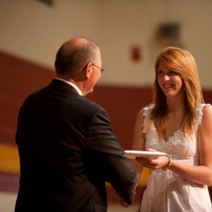 Kate Steury (New Paris, Ind.) receives her Hesston College diploma from President Howard Keim. Steury was one of 167 graduates of Hesston’s 102nd graduating class.