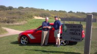 Tom West (left) shakes hands with Phil Nightingale, general manager of Mel Hambleton Ford, as he receives his hole-in-one prize of a 2013 Roush Stage 3 Ford Mustang at the Hesston College Kansas Golf Benefit at Prairie Dunes Country Club in Hutchinson.