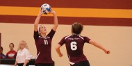 Maggie Lasater sets the ball for Lacey Crenshaw.