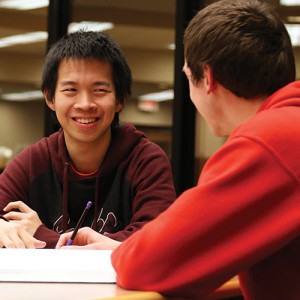 Kelvin Ferbianto and Jason Oyer work on homework together in the library. Photo by Alex Leff.
