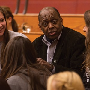 Tony Brown visits with students at a Hesston College basketball game.