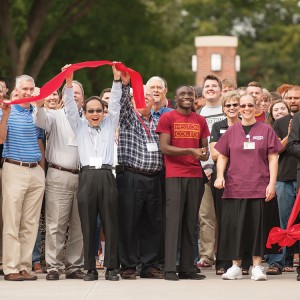 College and City of Hesston officials participate in the ribbon cutting for the college’s new campus entry Sept. 25.