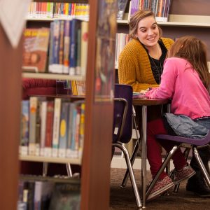 Caroline Riggenbach tutors a student at Hesston Public Library.