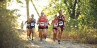 Hesston College women's cross country action photo - Eva Dwyer