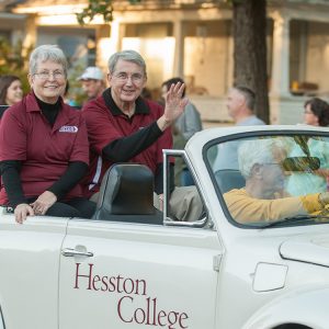 Interim President Ben Sprunger and his wife, Sue, ride in the community-wide Homecoming parade.