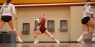 Hesston College volleyball action photo - Kylie Brenneman digs in a match with Cloud County CC, Oct. 6, 2017