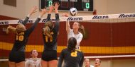 Hesston College volleyball action photo - Samantha Rossin spikes in a match with Cloud County CC, Oct. 6, 2017