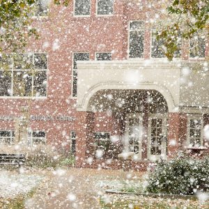 snow falls on the Hesston College campus