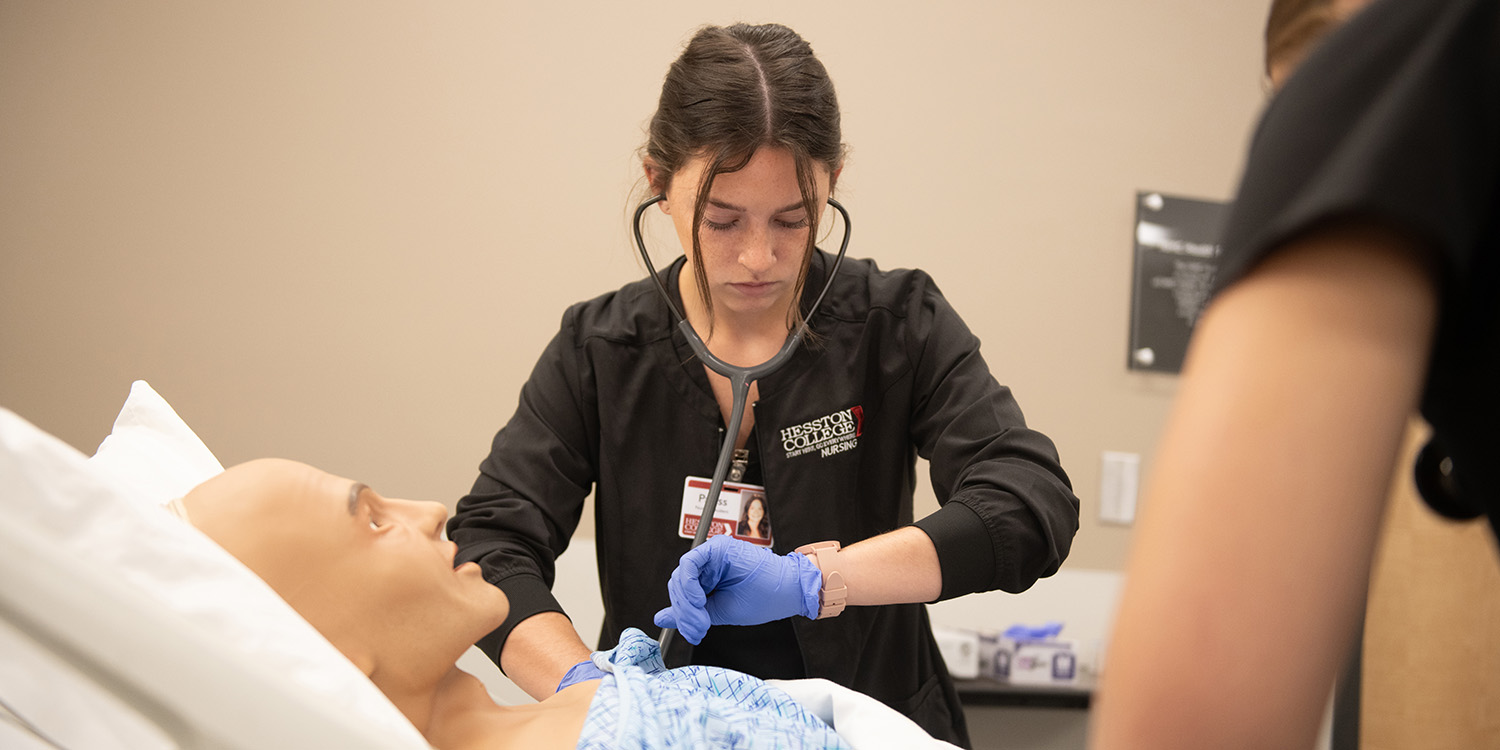 A nursing student hones her skills in the simulation lab.